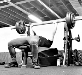 A lifter performs the bench press excercise